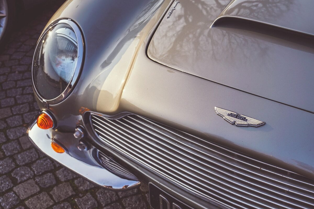 Crystal clear headlight and chrome grille on a classic Aston Martin
