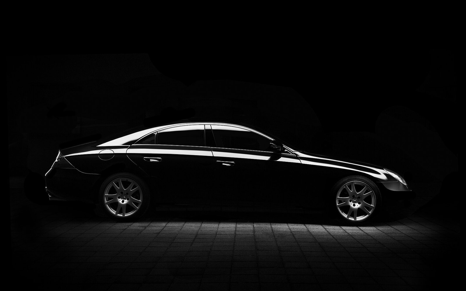 Black luxury car with a flawless paint finish under studio lighting