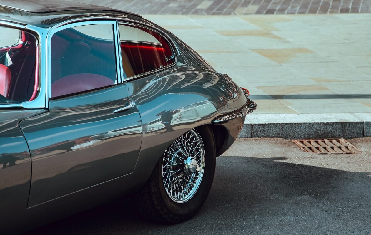 Polished grey Jaguar E-Type with chrome wire wheel