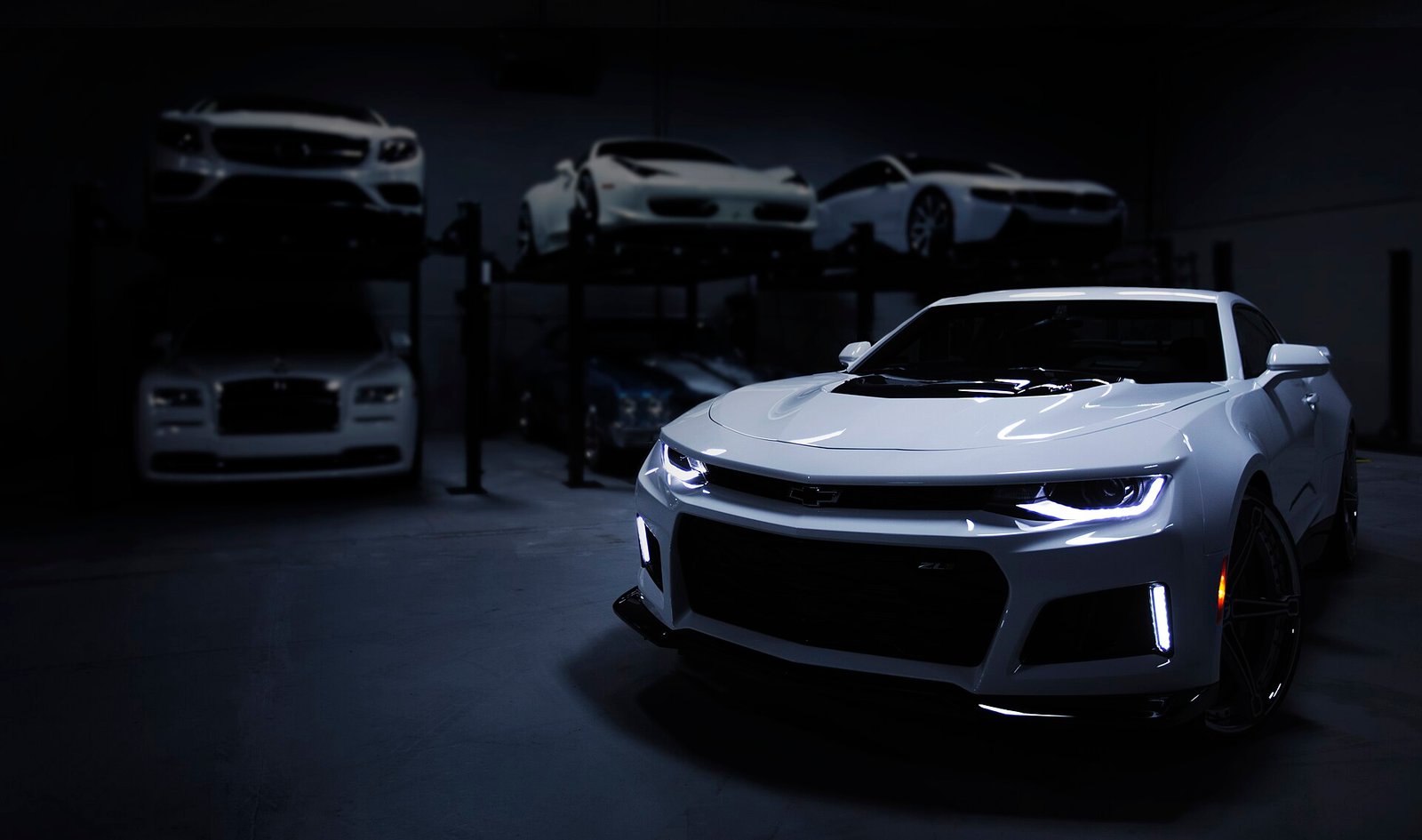 Detailing workshop with prestige cars on lifts