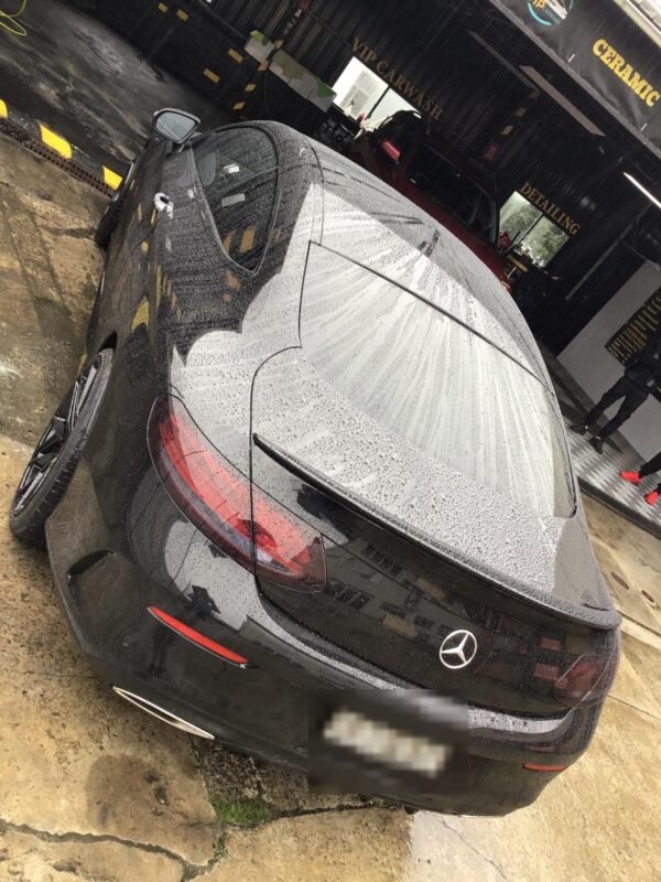 Water beading on the paint of a black Mercedes-Benz