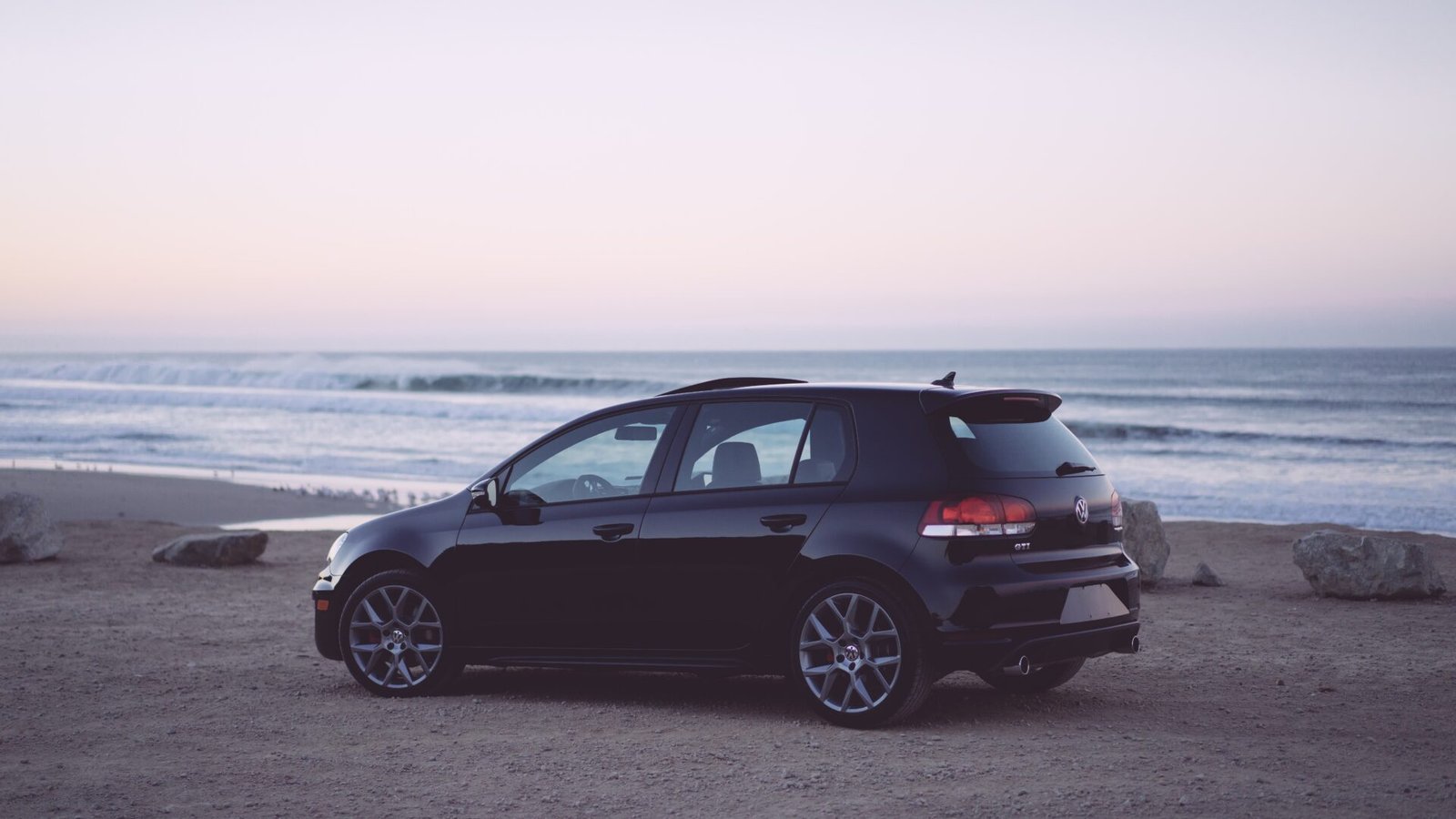 Black hatchback detailed on location at dusk