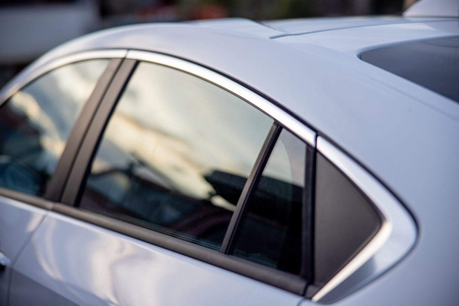Spotless side glass and paint on a silver car